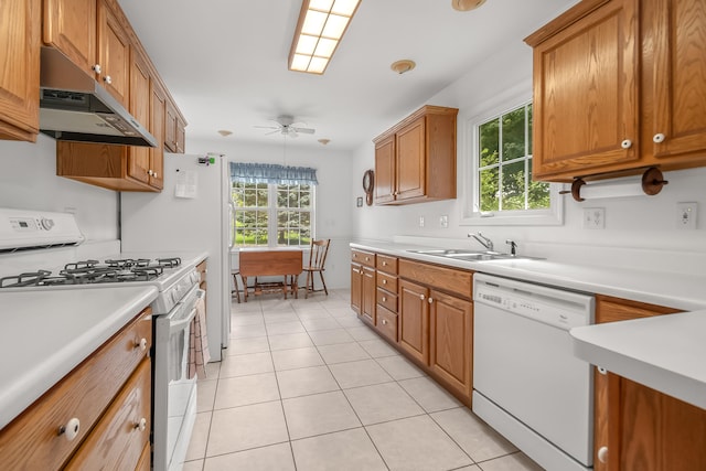 kitchen with white appliances, light tile patterned flooring, sink, and ceiling fan