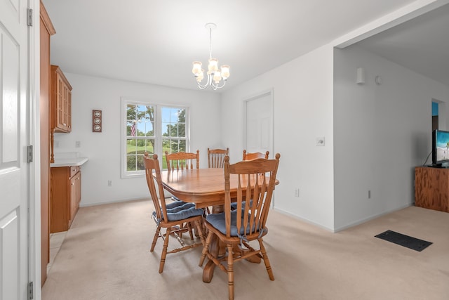 carpeted dining space with a notable chandelier