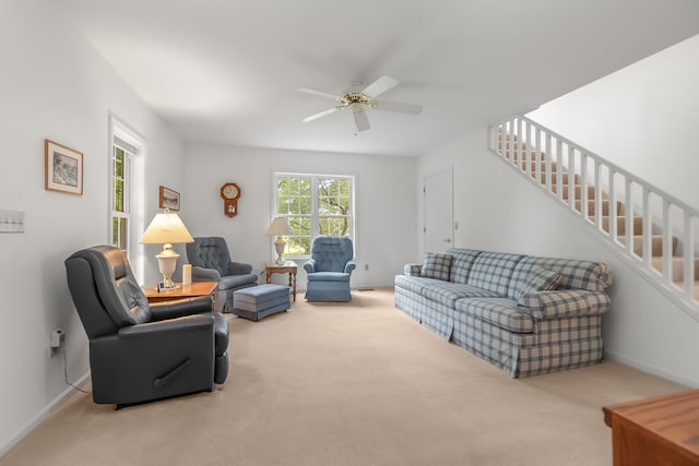 living room with light colored carpet and ceiling fan