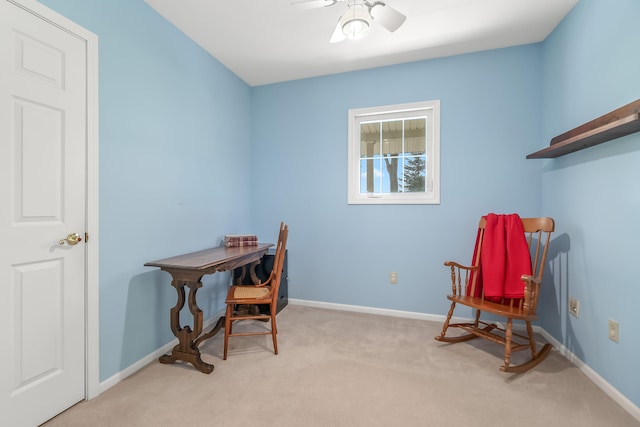 home office featuring light carpet and ceiling fan