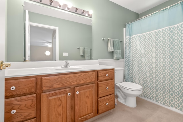 bathroom with vanity, toilet, and ceiling fan