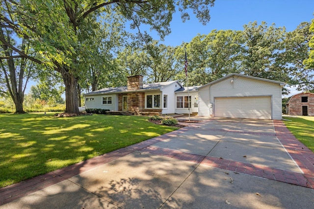 view of front of home featuring concrete driveway, a garage, a front yard, and a chimney