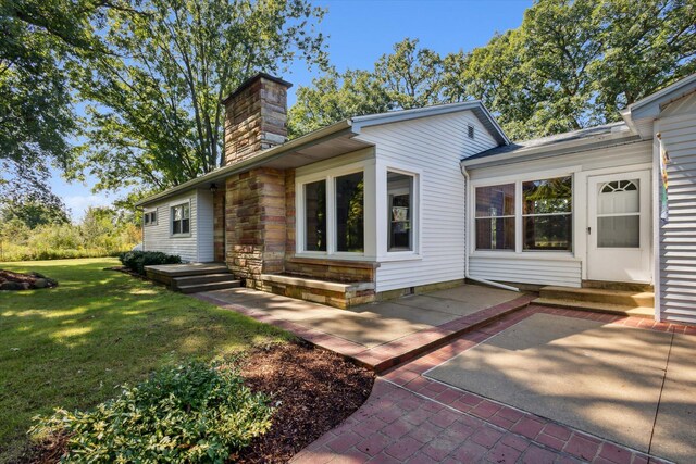 view of front facade with a front yard and a patio area