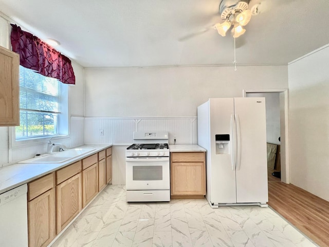 kitchen with light wood-type flooring, sink, light brown cabinets, and white appliances