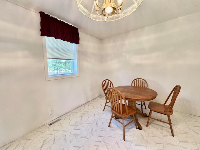 dining area with an inviting chandelier