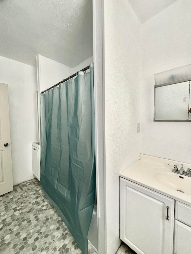 bathroom featuring vanity and shower / bath combination with curtain