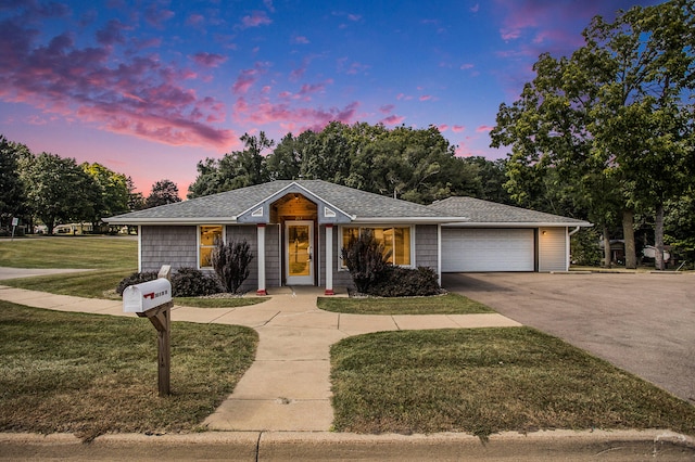 ranch-style home with a lawn and a garage