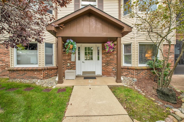 view of exterior entry with brick siding