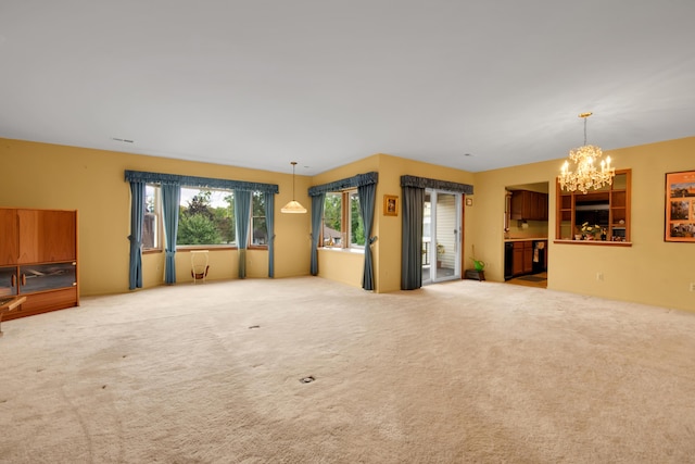 unfurnished room with carpet and an inviting chandelier