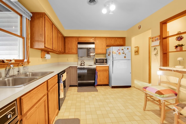 kitchen featuring visible vents, light countertops, brown cabinetry, white appliances, and a sink