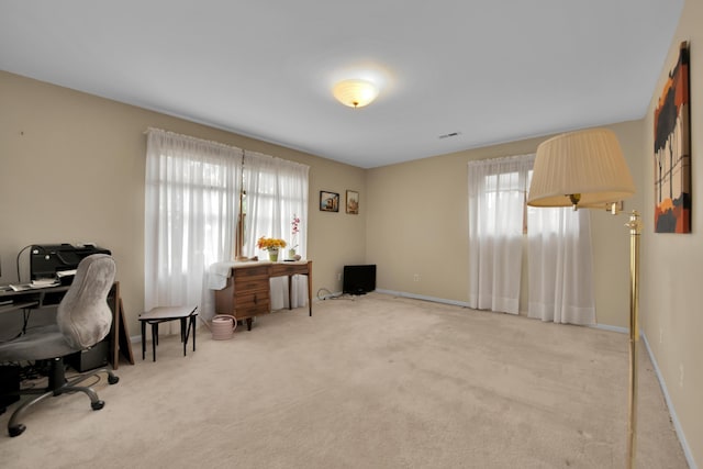 carpeted office space featuring baseboards