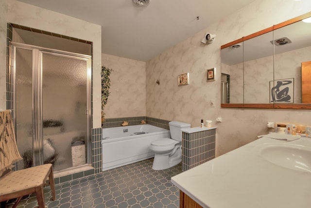 bathroom with vanity, a garden tub, toilet, and a stall shower