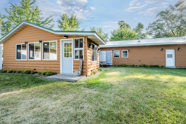 rear view of property with a yard