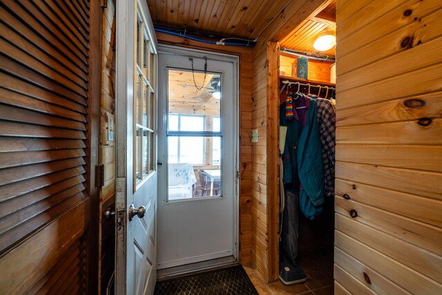 entryway featuring wood ceiling, a healthy amount of sunlight, and tile patterned flooring