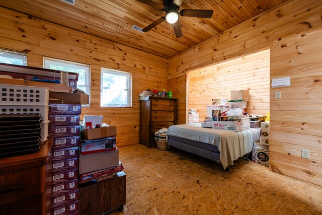 bedroom with wooden walls and ceiling fan