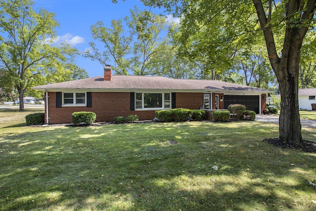 ranch-style home with a front yard, an attached garage, a chimney, concrete driveway, and brick siding