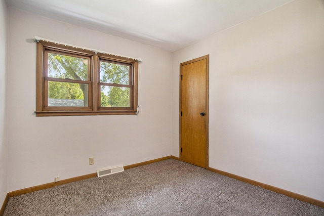 unfurnished room featuring visible vents, baseboards, and carpet