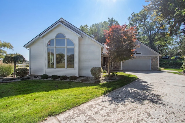 view of front of home with a garage and a front lawn