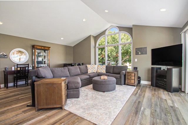 living room featuring vaulted ceiling and wood-type flooring