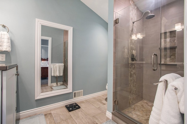 bathroom featuring lofted ceiling, toilet, and a shower with door