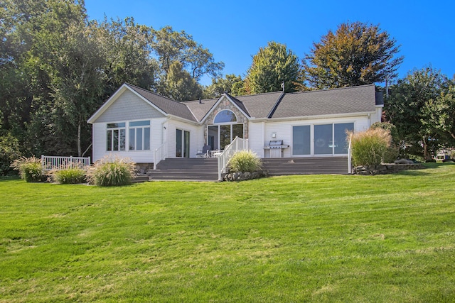 view of front of house featuring a wooden deck and a front lawn