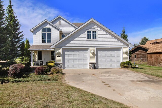 view of front of property featuring a garage and a front yard