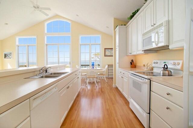 kitchen with white appliances, light hardwood / wood-style floors, sink, white cabinetry, and ceiling fan