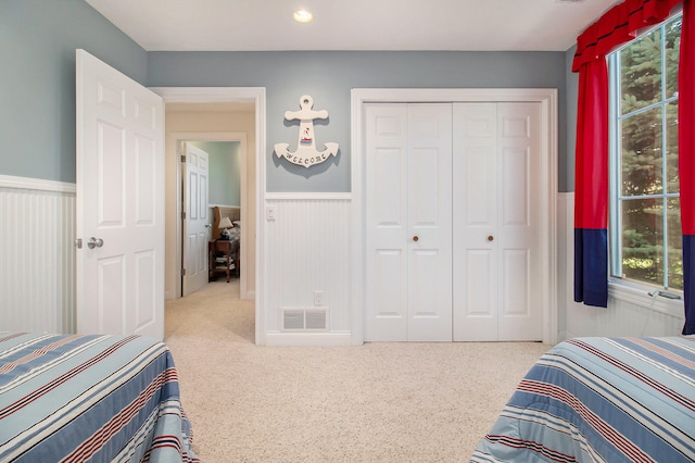 carpeted bedroom featuring a closet