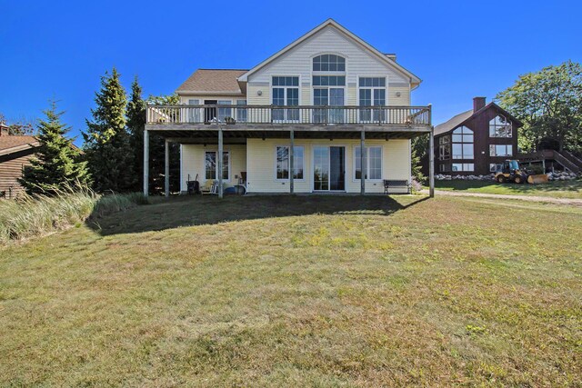 back of property featuring a yard and a wooden deck