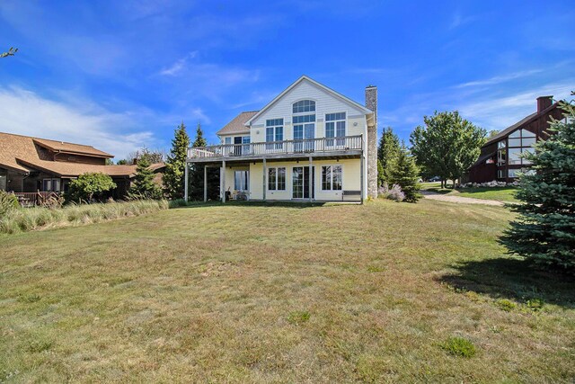 back of property featuring a lawn, a patio, and french doors