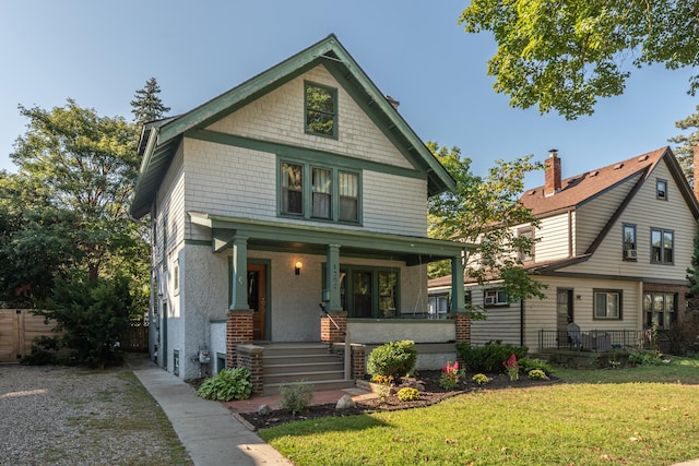 view of front of property with a front yard and covered porch