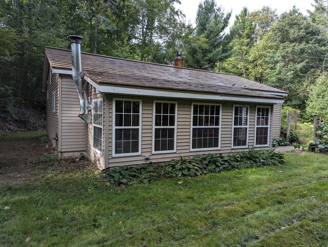 view of outbuilding featuring a yard