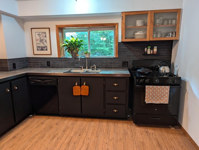 kitchen with black appliances, sink, light hardwood / wood-style flooring, and tasteful backsplash