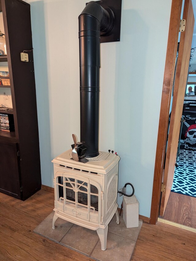 room details with wood-type flooring and a wood stove