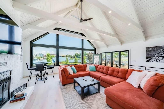 living room featuring high vaulted ceiling, ceiling fan, beamed ceiling, and hardwood / wood-style floors