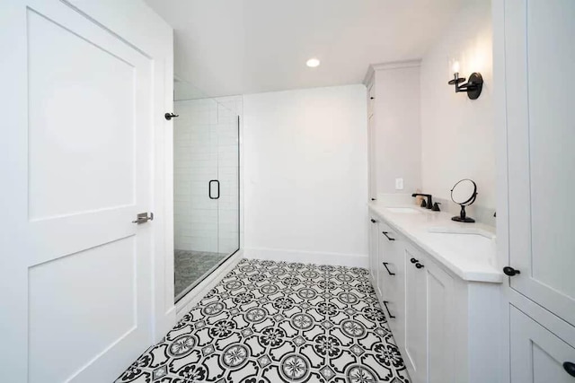 bathroom with tile patterned flooring, an enclosed shower, and vanity