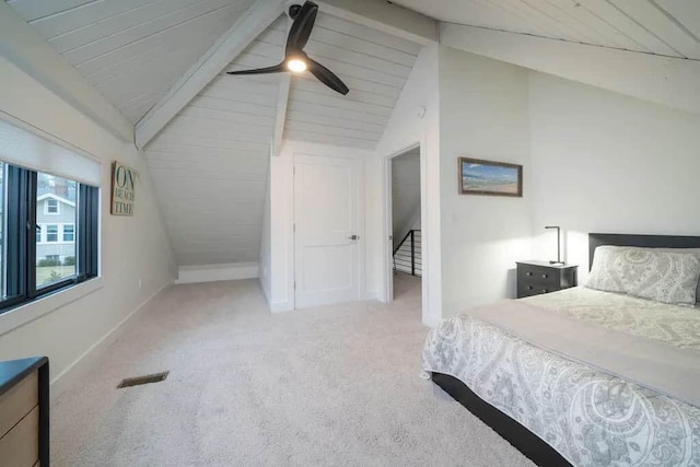 bedroom with ceiling fan, lofted ceiling with beams, and carpet