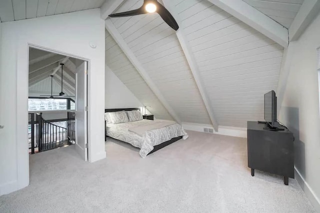 carpeted bedroom featuring ceiling fan, lofted ceiling with beams, and wooden ceiling