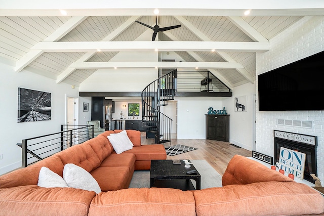 living room with wood ceiling, high vaulted ceiling, beam ceiling, ceiling fan, and hardwood / wood-style floors