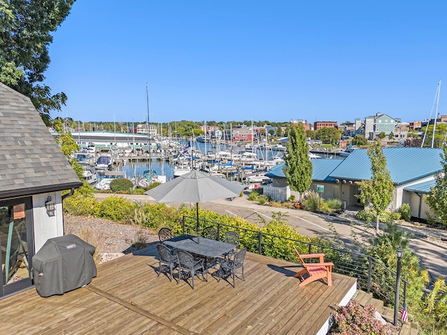 wooden deck featuring area for grilling and a water view