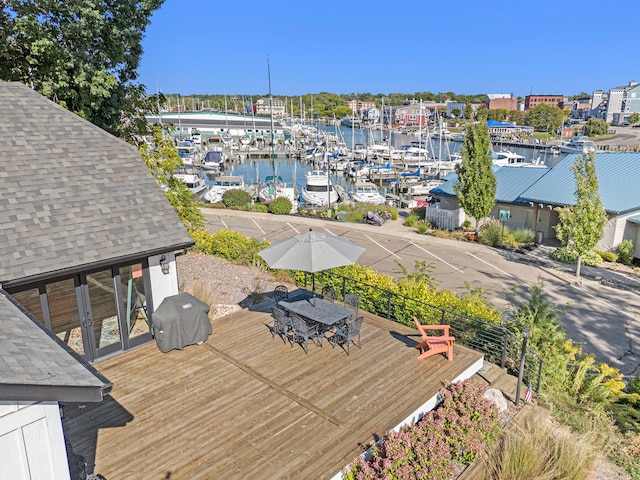 wooden deck with a water view and grilling area