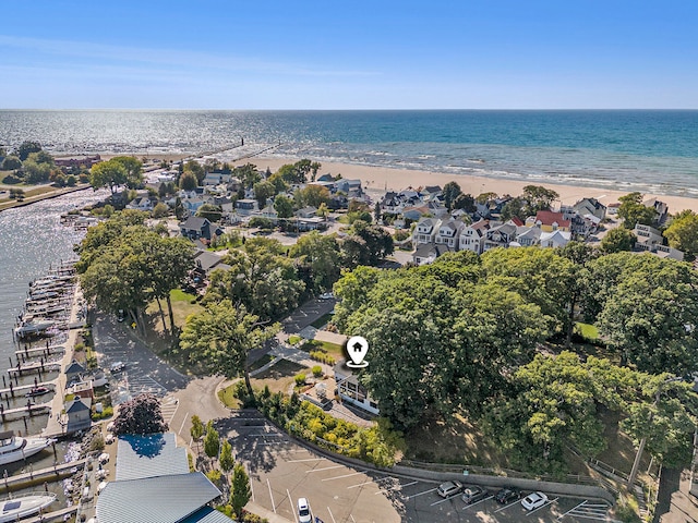 drone / aerial view with a beach view and a water view