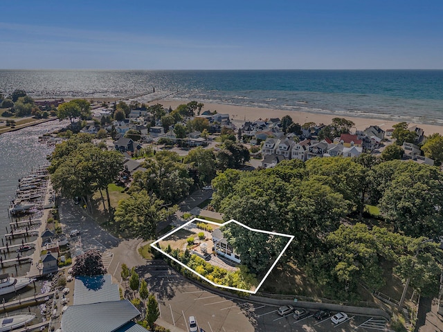 aerial view with a water view and a beach view