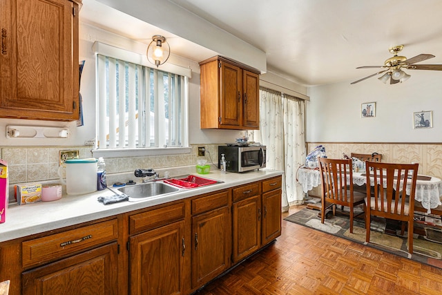 kitchen featuring a wealth of natural light, parquet floors, ceiling fan, and sink