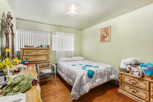 bedroom with hardwood / wood-style flooring