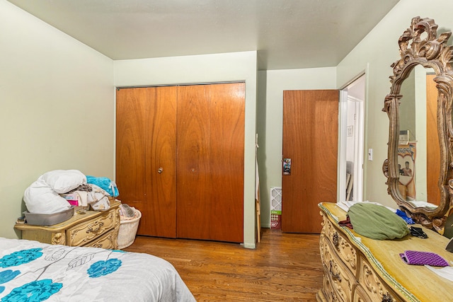 bedroom featuring dark hardwood / wood-style floors and a closet