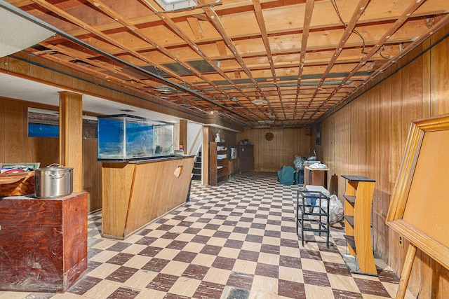 basement featuring wooden walls