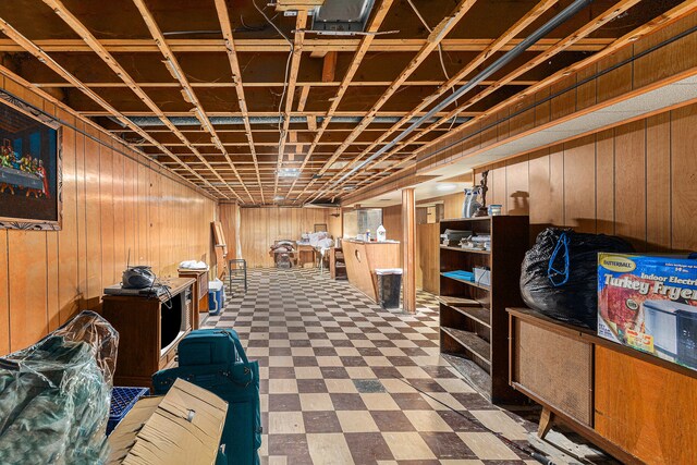 basement featuring wood walls