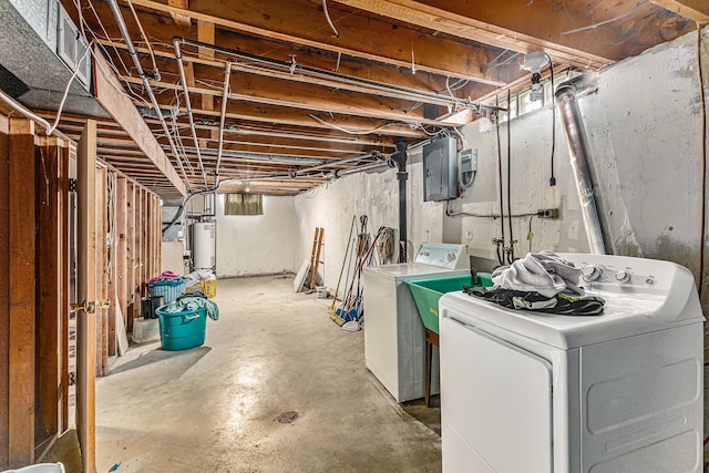 basement with gas water heater, independent washer and dryer, and electric panel