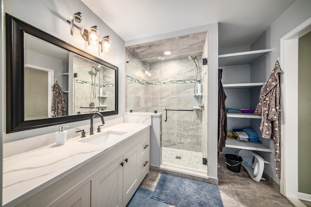 bathroom with tile patterned floors, an enclosed shower, and vanity